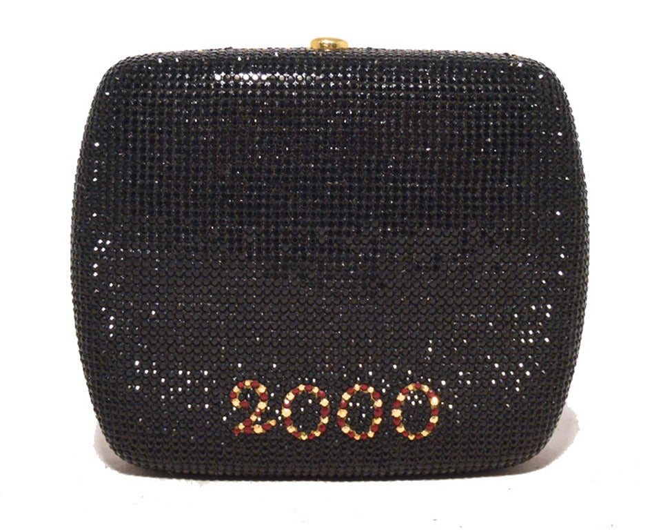 EXTREMELY RARE Limited Edition JUDITH LEIBER swarovski clock minaudiere in MINT condition. Swarovski crystal exterior with black, clear, and various colored crystals in a clock design celebrating the start of a new century in 2001.  Push button top