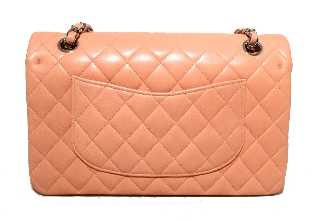 FABULOUS CHANEL quilted nude pink double flap classic in excellent condition.  Nude pink quilted lambskin exterior trimmed with silver hardware.  Signature CC twist closure opens to a matching leather lined interior that holds 3 slit pockets, 1