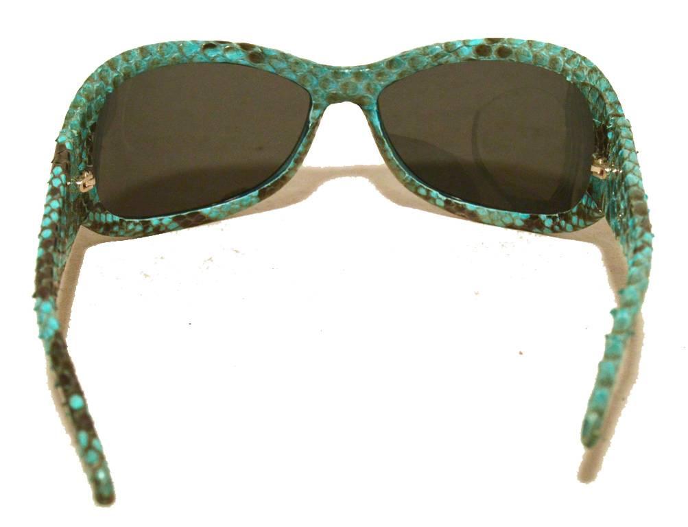 Impeccable Techno Marine blue snakeskin sunglasses in excellent condition.  Blye snakeskin frames with grey oval lenses and embellished silver hardware. Both sides feature a crysal encrusted 