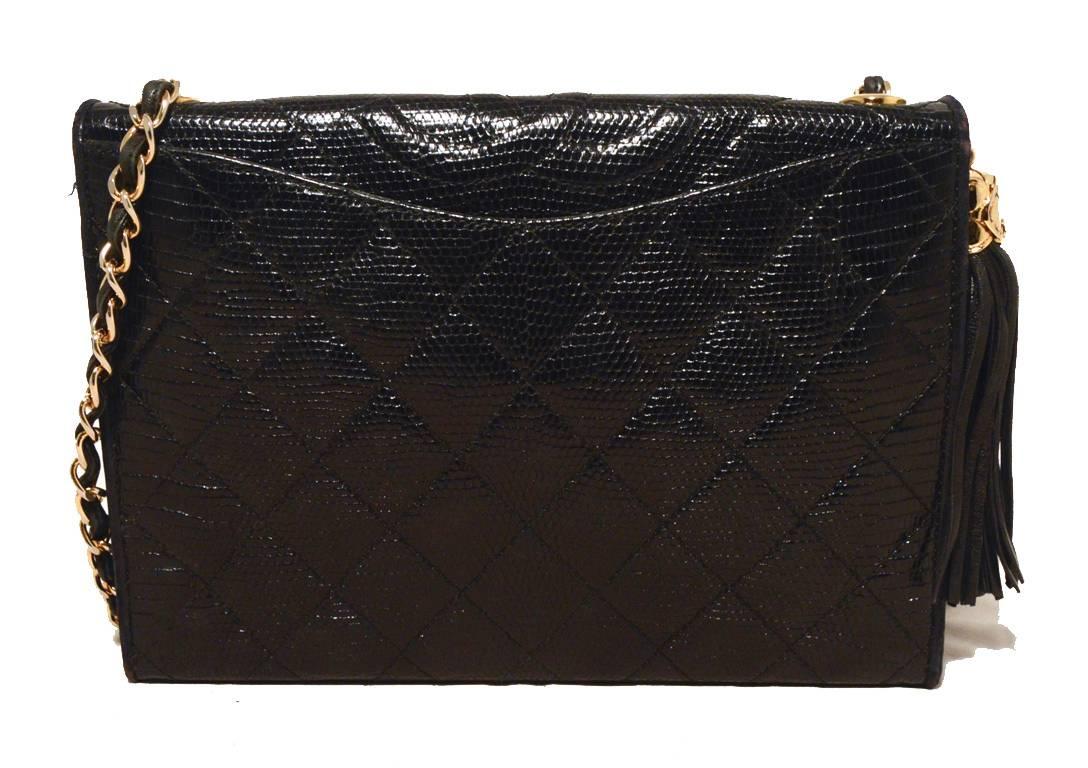 AMAZING Vintage CHANEL black lizard leather shoulder bag in very good vintage condition.  Black lizard leather exterior trimmed with a side leather tassel detail, gold hardware, and one slit pocket on the backside.  Signature woven leather and chain