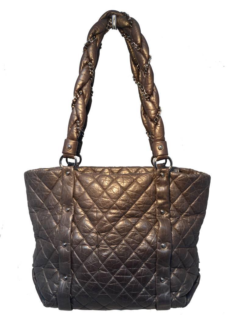 FABULOUS CHANEL grey leather shopper tote in very good condition.  Quilted dark grey distressed leather exterior trimmed with gunmetal hardware.  Leather and chain wrapped double shoulder straps. Front zippered pocket.  Top zipper closure opens to a
