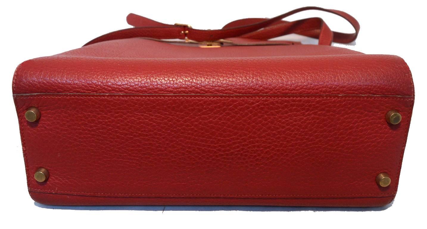 UNIQUE HERMES rouge kelly sport shoulder bag in excellent vintage condition. Rouge clemence leather exterior trimmed with gold hardware. Signature kelly style twist closure opens to a matching rouge red leather lined interior that holds 1 zippered