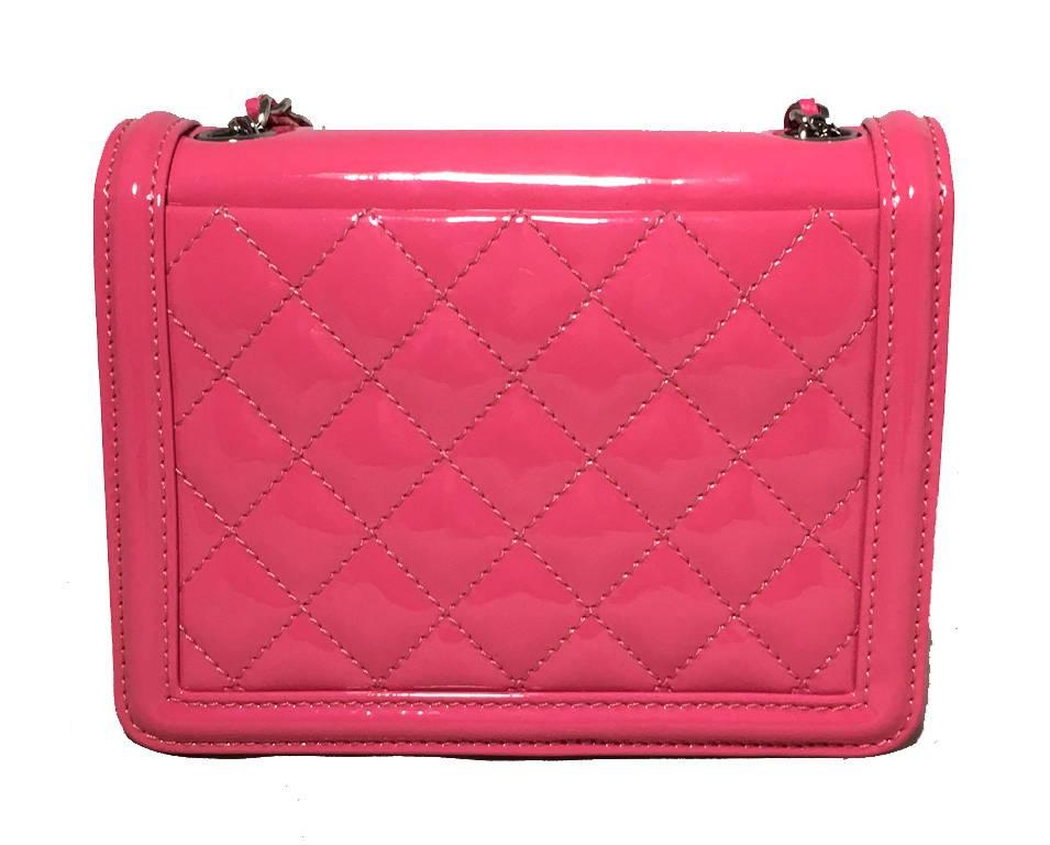 LIMITED EDITION Chanel pink patent leather mini classic flap bag in excellent condition.  Pink patent leather exterior with woven silver chain and leather shoulder strap that has a patent leather strip on shoulder.  Front features a unique block