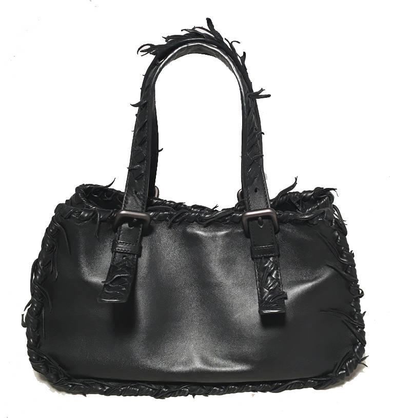 GORGEOUS Bottega Veneta black leather handbag in excellent condition.  Black lambskin leather with woven leather bottom.  Unique woven edges and handles trimmed with leather fringe edges.  Top snap closure opens to a brown suede lined interior that
