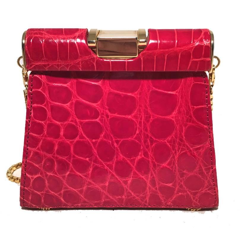 Beautiful Vintage Escada red alligator mini bag in excellent condition.  Bright red alligator leather exterior trimmed with gold hardware.  Chain shoulder strap can be removed to use this piece as a clutch.  Lifting top closure opens to a brown