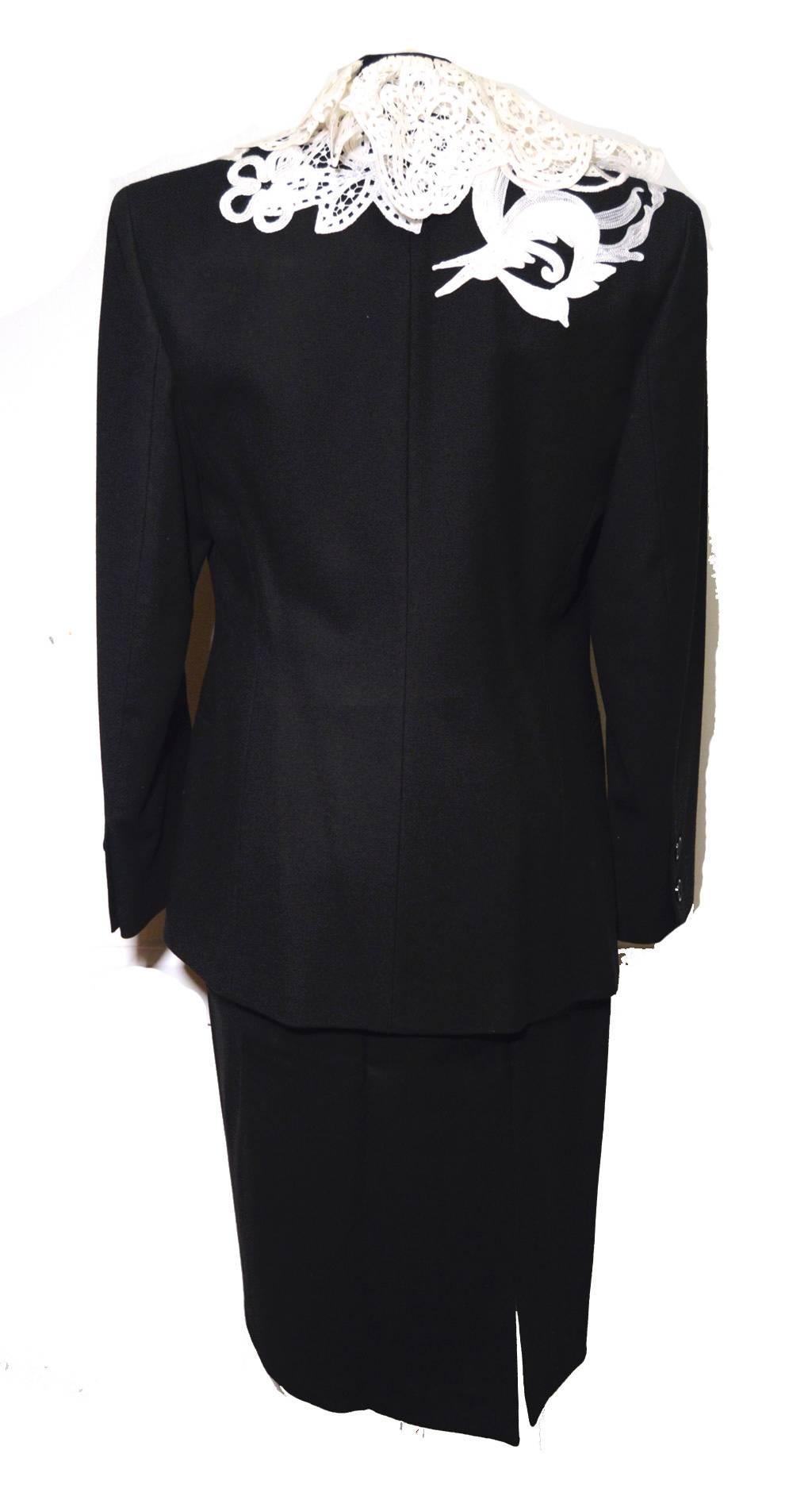 Gianfranco Ferre for Nan Dunskin vintage black wool suit c1980s 100% wool trimmed with hand made white lace and white stitched embroidery along the top neckline and lapel carrying over onto part of the bodice and back.  No front closure.  Fully