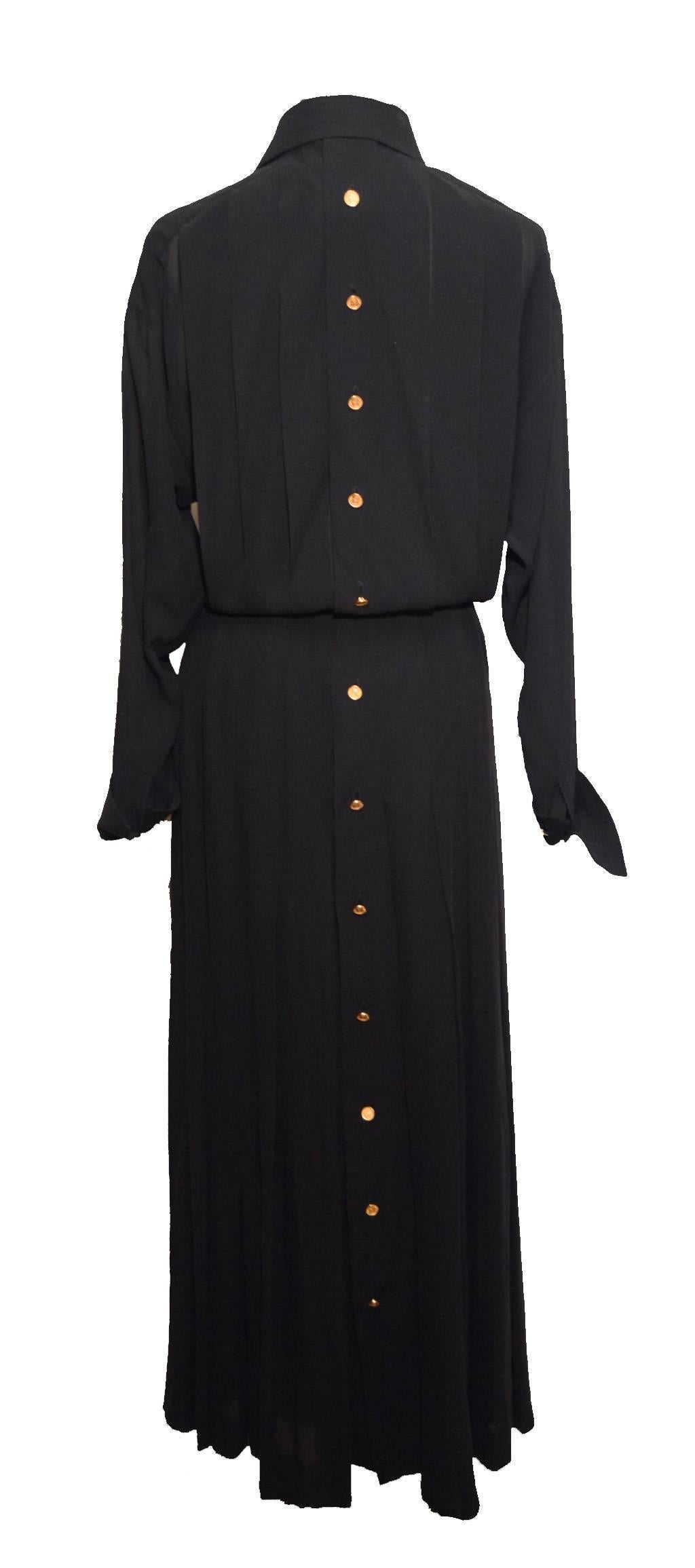 Black medium weight silk dress.  This classic career girl dress has a box pleated blouson top and box pleats extending below the hip to the hem of the skirt.  Pointed collar.  Both collar and cuffs have rows of straight stitching as