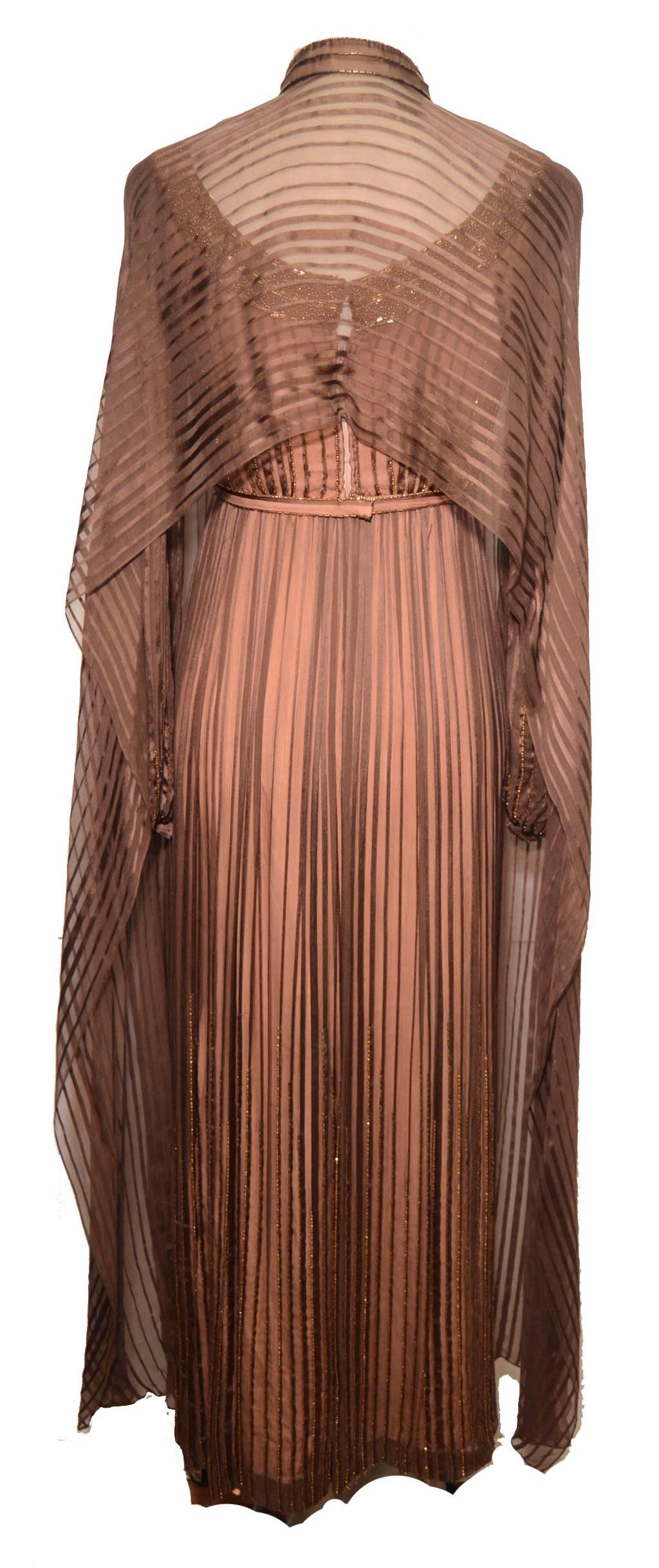 Stunning Alfred Bosand beaded silk chiffon gown and shawl c1960s.  Brown silk chiffon over a peach silk lining trimmed with delicate hand beading along the collar, bust, hem, and sleeves. Beaded scoop neck in brown and bronze beads.  Empire style