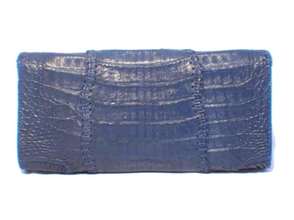 This simply stunning Carlos Falchi clutch is a must have for any collector’s wardrobe. The exterior is in beautiful condition featuring patch worked blue crocodile leather that has been uniquely stitched together creating a gorgeous bohemian design.