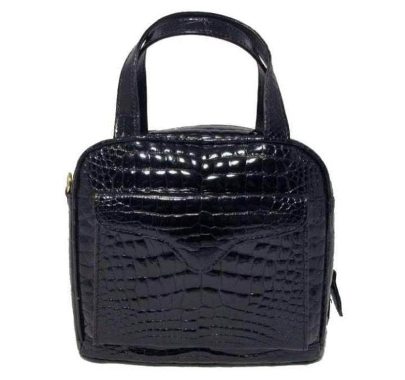 This beautiful Lana Marks handbag is in excellent condition. The exterior features gorgeous black patent alligator leather with one exterior pocket and a 36 inch removable shoulder strap. The full zippered closure opens to a stunning interior fully