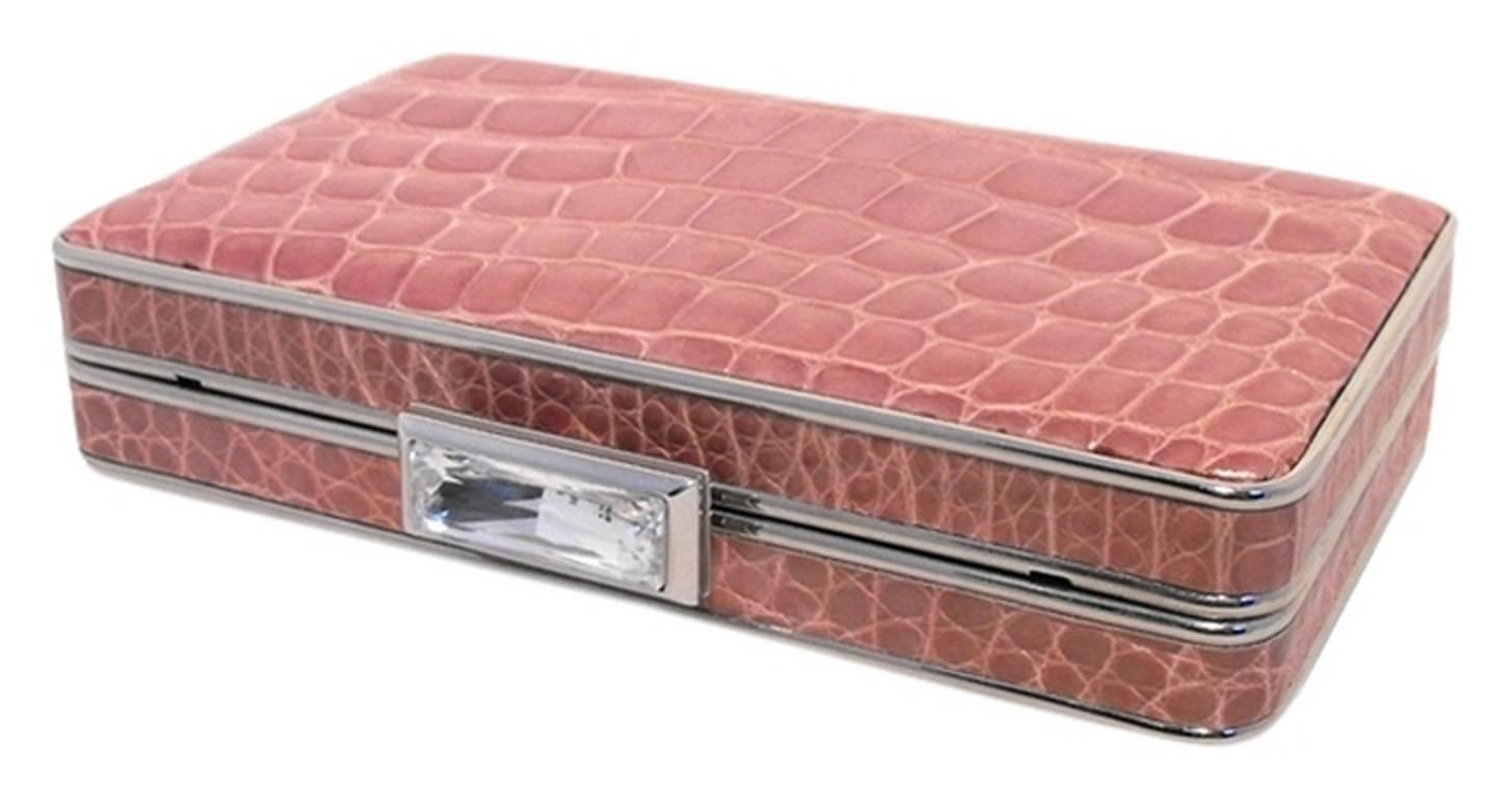 FABULOUS JUDITH LEIBER pink alligator box clutch in excellent condition.  Pink alligator exterior trimmed with silver hardware and a stunning clear swarovski crystal detail.  Lift latch closure opens to a silver leather lined interior that holds a