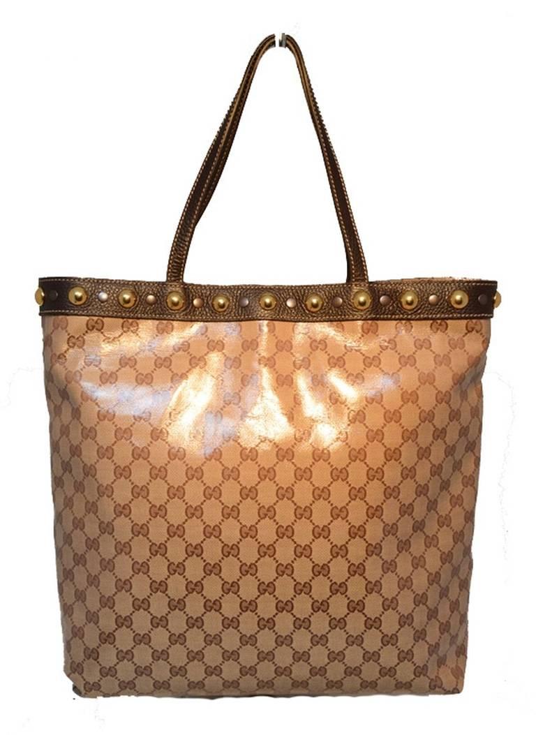 FABULOUS GUCCI Studded shopper tote in excellent condition. Coated monogram canvas exterior trimmed with dark brown leather and gold and silver studs along the top edge. Brown nylon lined interior with one side zippered pocket and ample storage