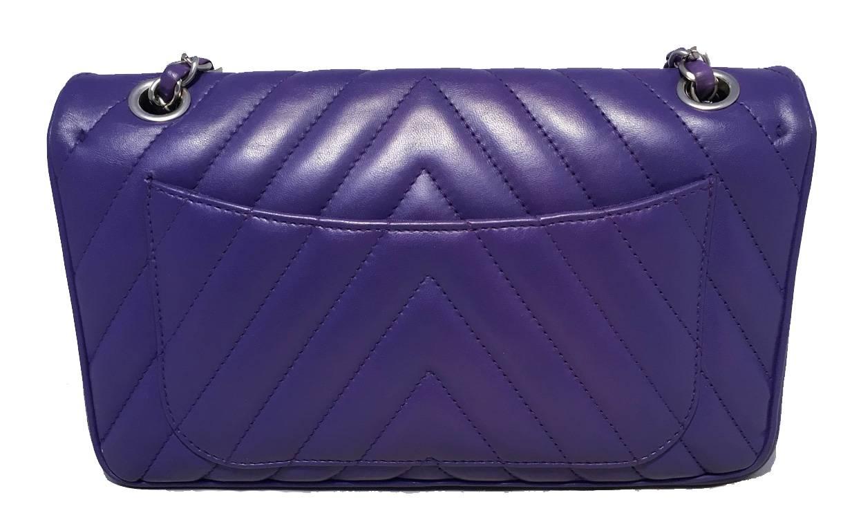 STUNNING Chanel purple classic flap shoulder bag in excellent condition.  Purple lambskin leather exterior quilted in a unique chevron v shape pattern.  Matte silver hardware and signature woven chain and leather shoulder strap that can be worn long