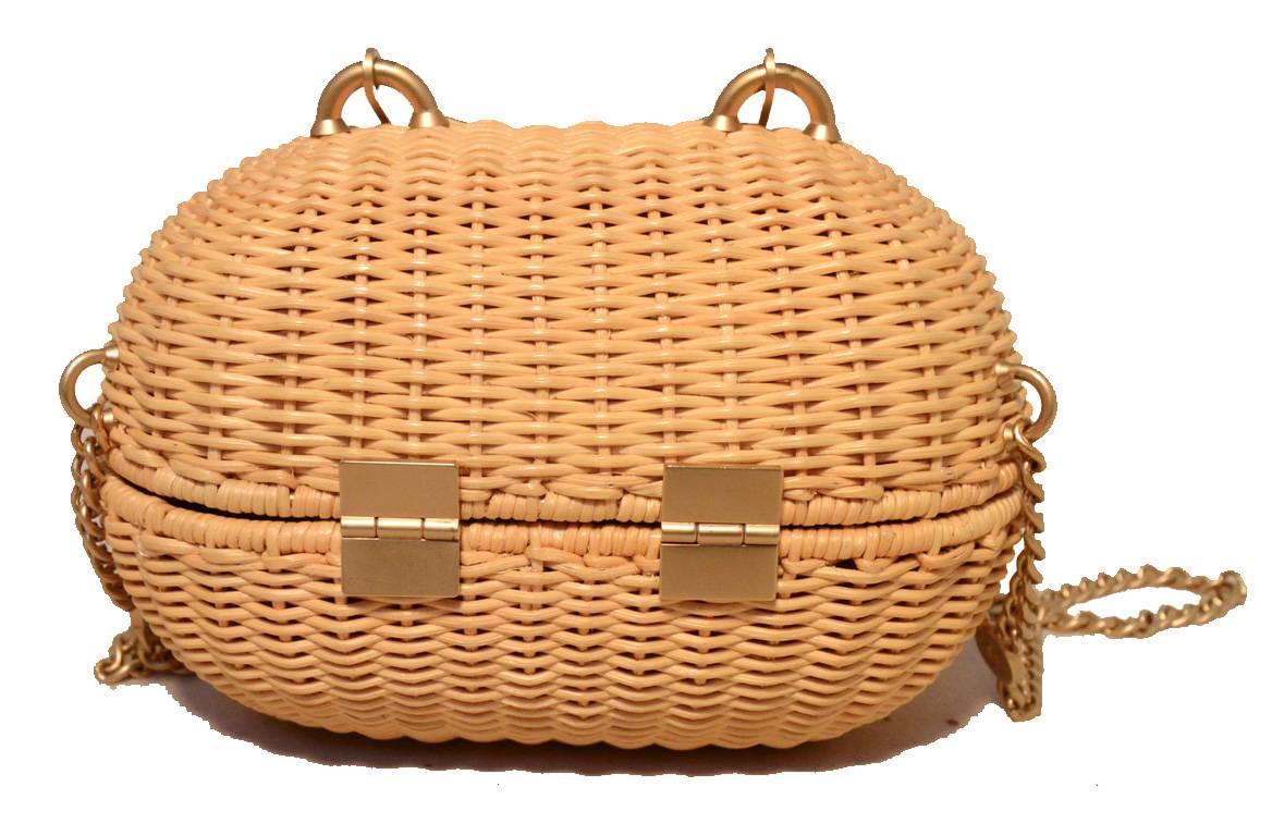 Adorable Chanel wicker handbag in excellent condition.  Tan woven wicker exterior trimmed with matte gold hardware and chain shoulder strap.  Sliding heart shaped latch closure opens to a light tan nylon lined interior.  Excellent condition, no