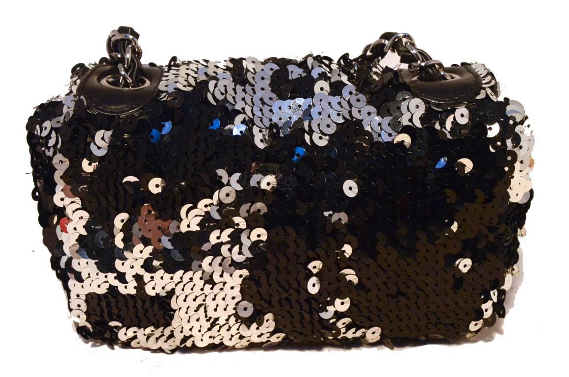 GORGEOUS Chanel sequin mini classic flap in excellent condition.  Black, silver, and grey sequin exterior trimmed with gunmetal hardware and woven chain and leather shoulder strap.  Front CC logo snap closure opens to a black satin and leather lined