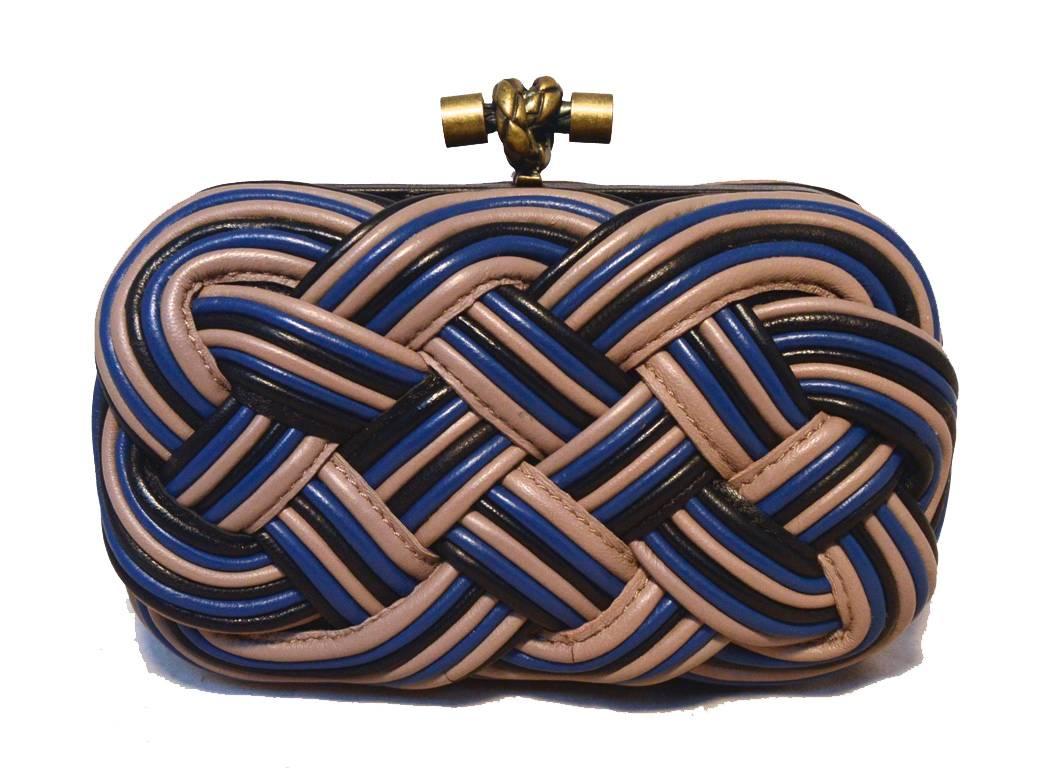 Beautiful Bottega Veneta braided leather clutch in excellent condition.  Black leather body with braided blue, black, and tan corded leather.  Top bronze lifting closure lifts open to a beige silk lined interior.  Excellent condition, no stains,