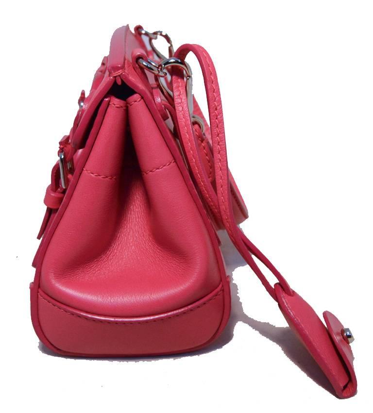 STUNNING Ralph Lauren mini ricky bag in excellent condition.  Hot pink leather exterior trimmed with silver hardware.  Double buckle strap and front lock closure opens to a pink and orange leather lined interior that holds one side snap pocket. 