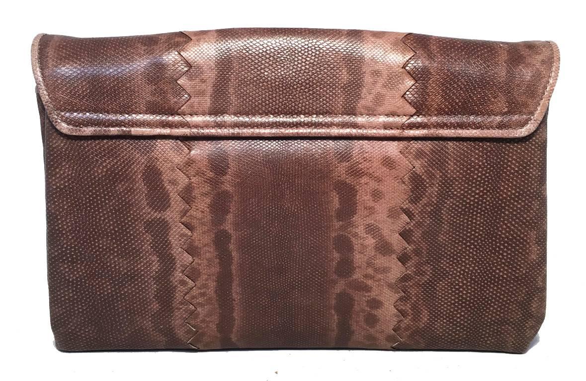 Gorgeous Bottega Veneta brown lizard leather clutch in excellent condition. Brown lizard leather exterior with front twist closure. Pleated expandable interior design features 2 separate compartments, one with an additional zippered side pocket.