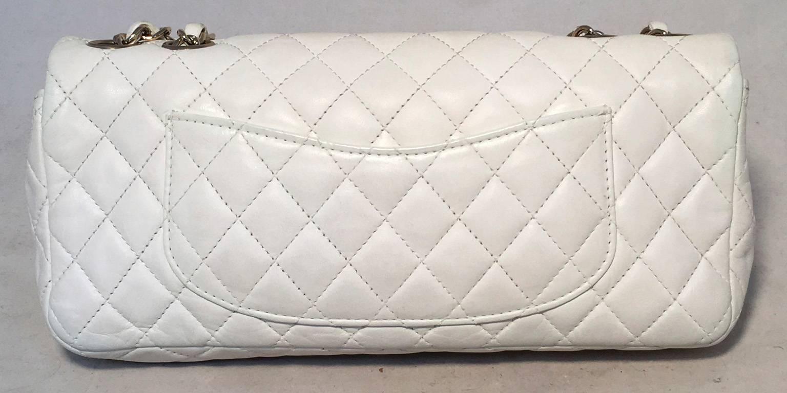 Beautiful Chanel heart charms classic flap in excellent condition.  Quilted white leather exterior trimmed with silver hardware and 6 adorable heart charms along the chain shoulder strap.  Front CC Logo twist closure opens single flap style to a