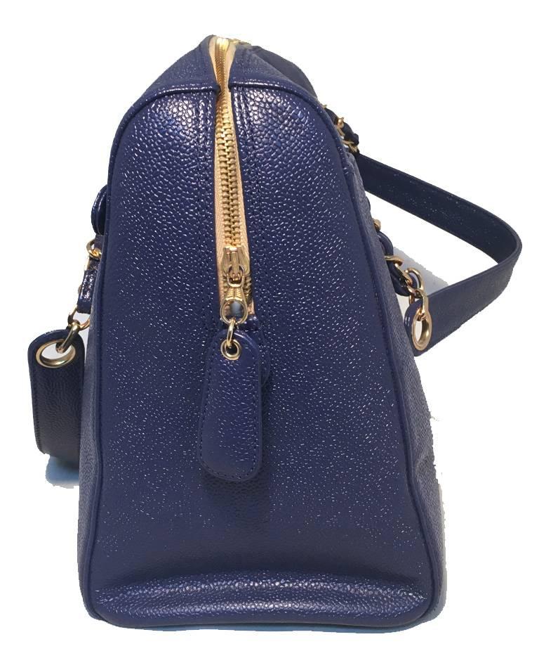 GORGEOUS Chanel caviar leather tote in excellent condition.  Royal blue caviar leather exterior trimmed with double woven chain and leather shoulder straps and gold hardware.  Front slit pocket and back side zippered pocket.  4 gold feet along