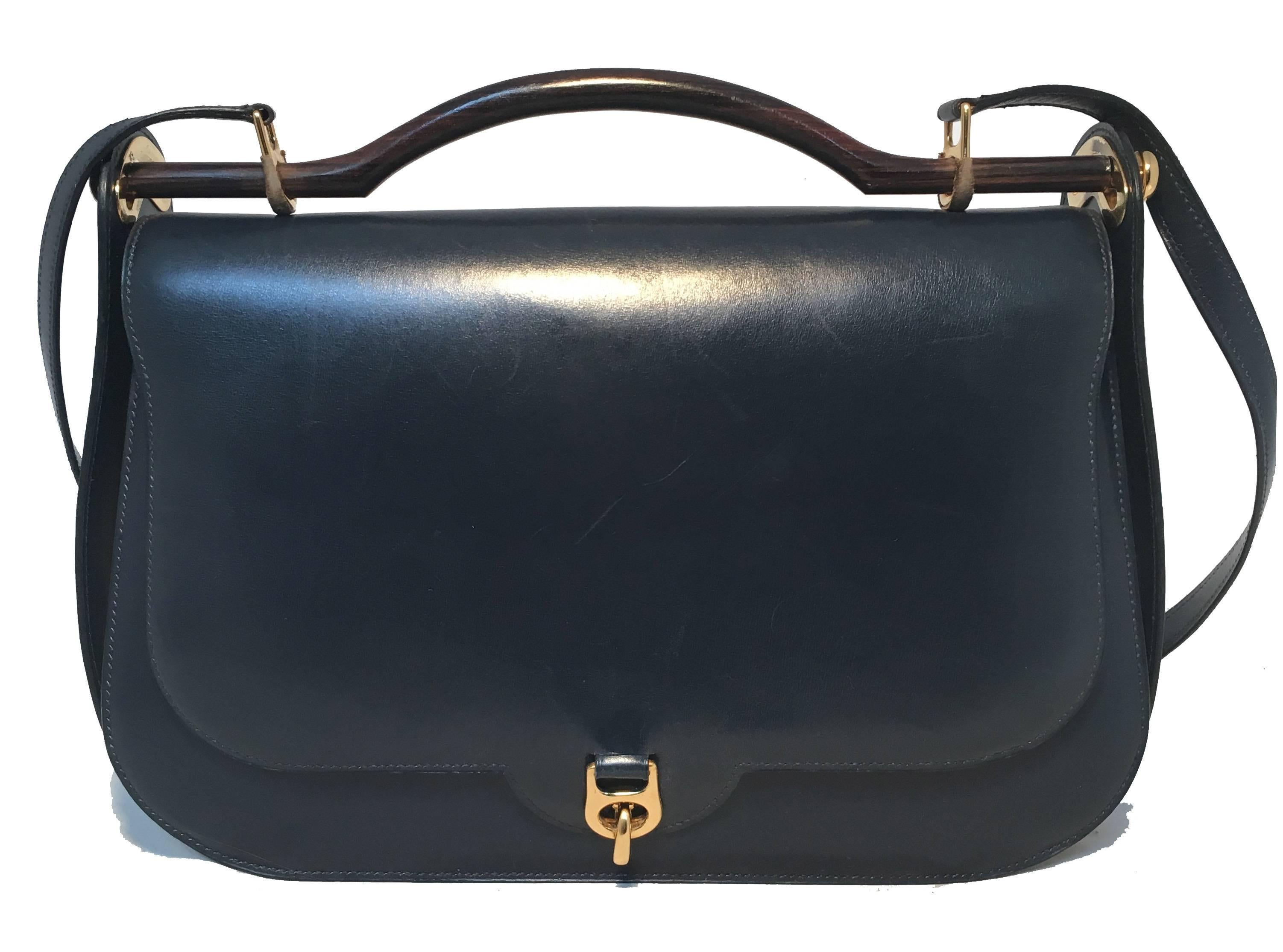 GORGEOUS vintage Hermes navy blue shoulder bag in very good condition.  Navy blue box calf leather trimmed with gold hardware and wooden top handle.  Front latch closure opens to a navy blue leather lined interior that holds 1 side slit pocket and