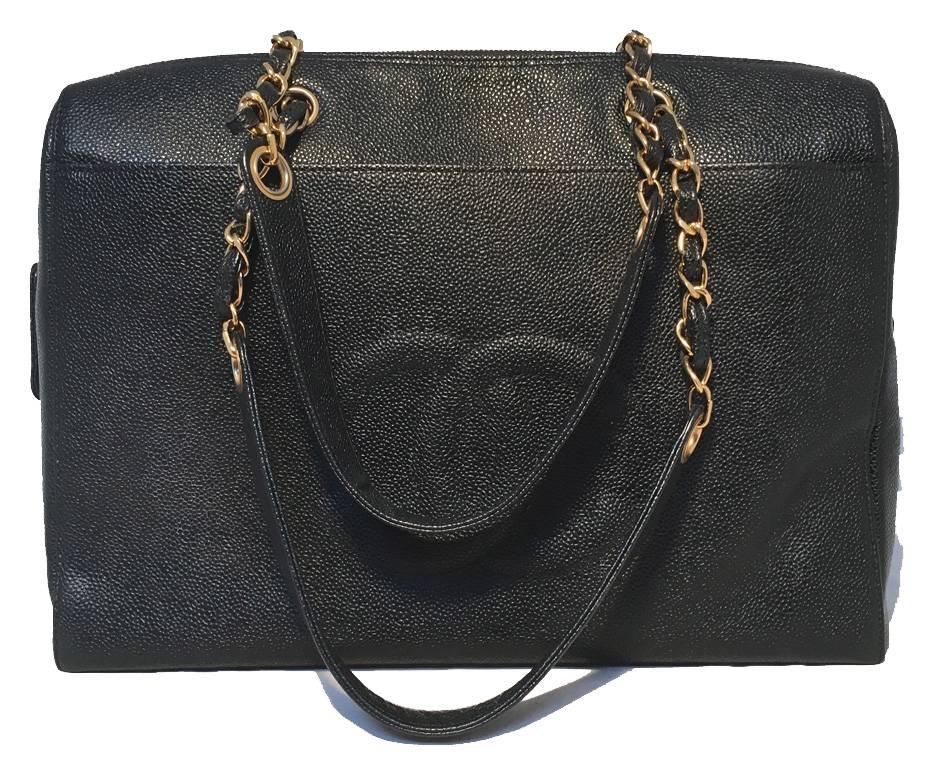 GORGEOUS Chanel caviar leather tote in excellent condition. Black caviar leather exterior trimmed with double woven chain and leather shoulder straps and gold hardware. Front slit pocket and back side zippered pocket. 4 gold feet along bottom. Top
