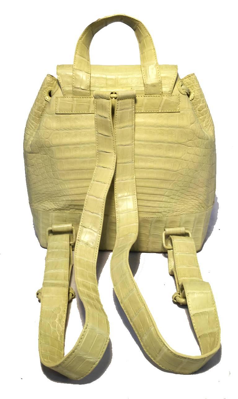 GORGEOUS Nancy Gonzalez crocodile backpack in excellent condition.  Yellow genuine crocodile leather exterior with adjustable crocodile back straps and two front flap pockets.  Top flap and drawstring closure opens through a hidden magnetic closure