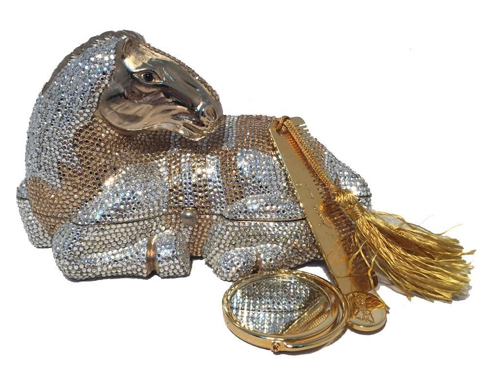 Breathtaking Judith Leiber crystal horse minaudiere in excellent condition.  Silver and gold Swarovski crystals surround a gold resting horse designed form finished with black crystal eyes.  Side button closure opens to a gold leather interior.