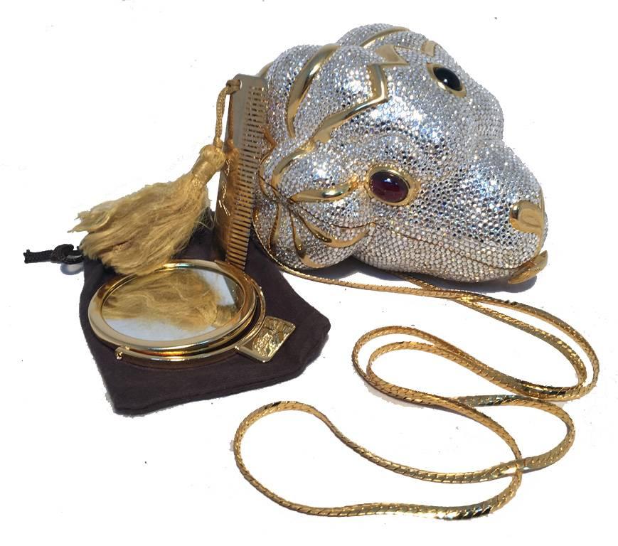 GORGEOUS JUDITH LEIBER ram head minaudiere in excellent condition.  Swarovski crystal exterior over a gold form with garnet glass eyes.  Front button closure opens to a gold leather lined interior that holds an attached gold chain shoulder strap. 