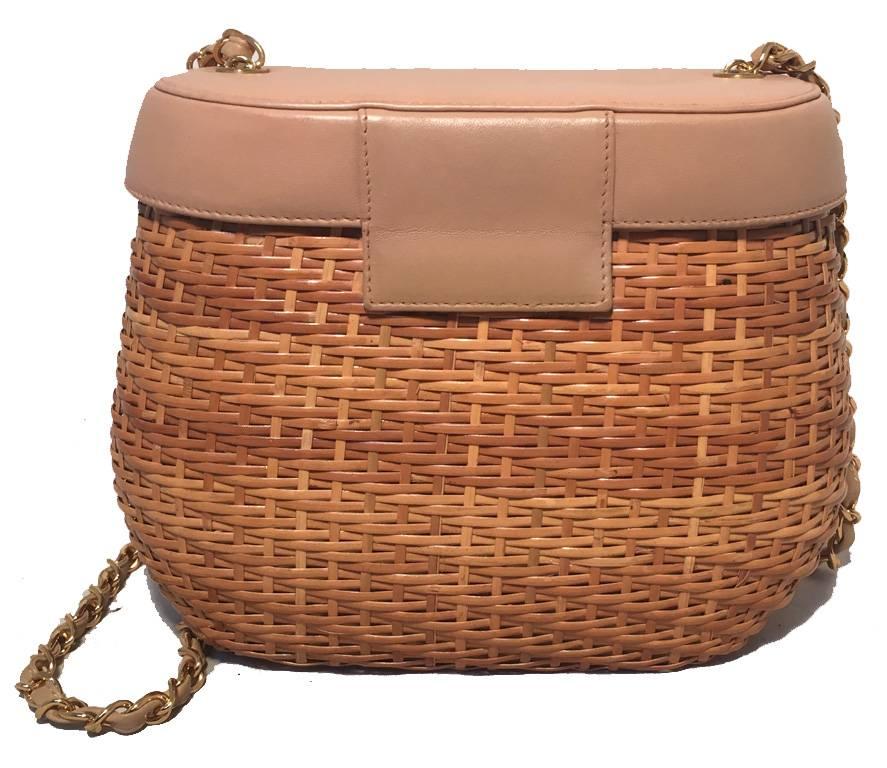 GORGEOUS CHANEL basket bag in excellent condition.  Tan rattan wicker with a tan leather top and gold hardware. Signature woven gold chain and leather shoulder strap. Front twist CC logo closure opens to a tan leather interior that holds 1 slit and