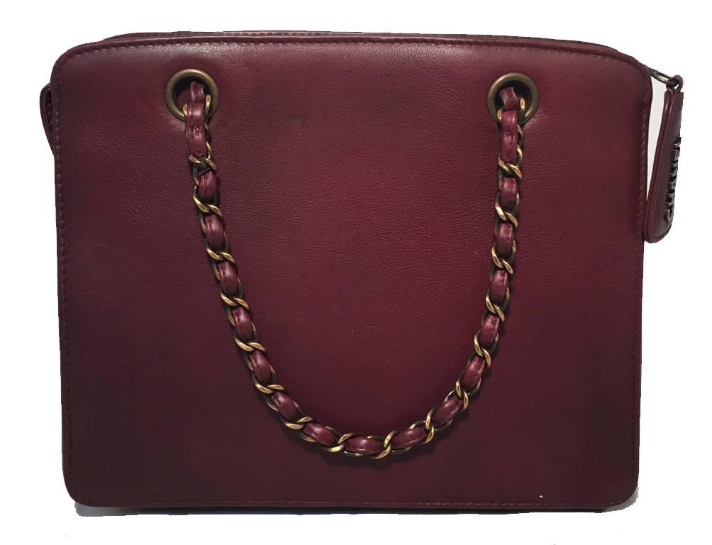 RARE CHANEL maroon leather handbag in very good condition.  Beautiful maroon leather exterior trimmed with antiqued bronze hardware and signature woven chain and leather handles on both the front and back. Top zipper closure opens to a matching