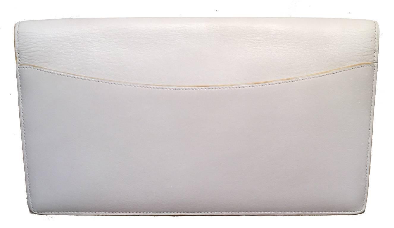 Beautiful vintage Hermes clutch in very good condition.  White box calf leather exterior with signature H logo along front flap and back side exterior slit pocket.  Front snap closure opens to a matching white leather lined interior that holds 2