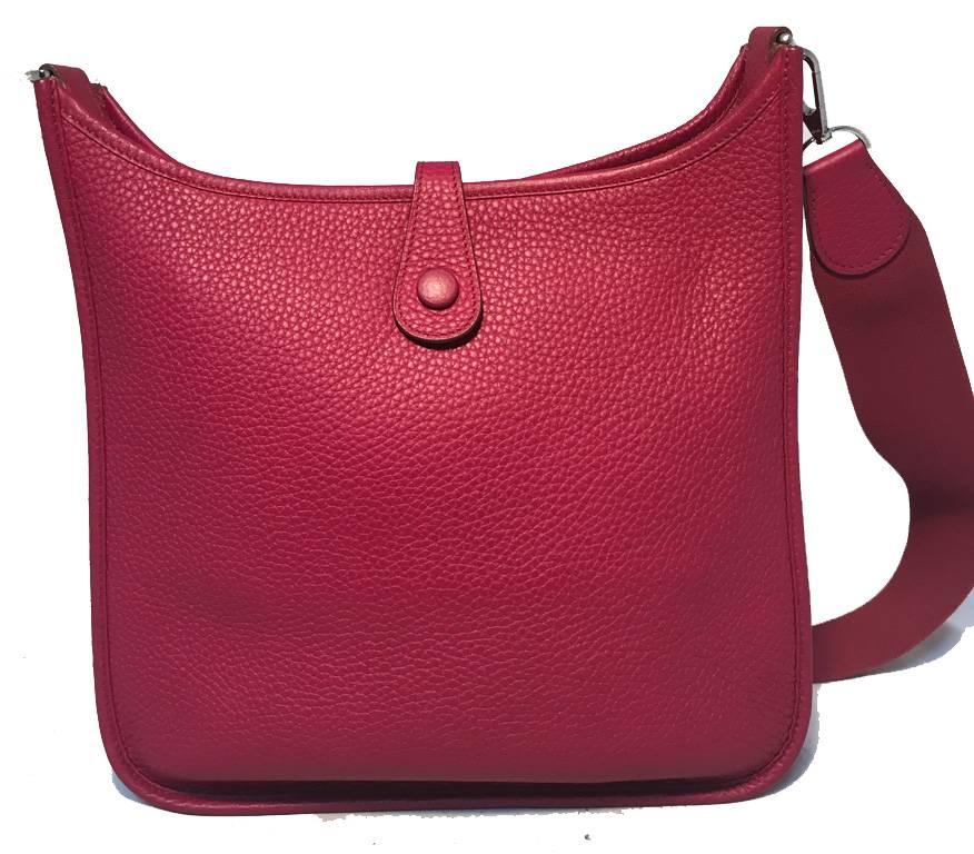 RARE Hermes Cherry Clemence Leather Evelyn PM Shoulder Bag in excellent condition.  Rare cherry red deep burgundy clemence leather exterior trimmed with silver palladium hardware.  Woven canvas shoulder strap.  Single snap strap closure opens to an