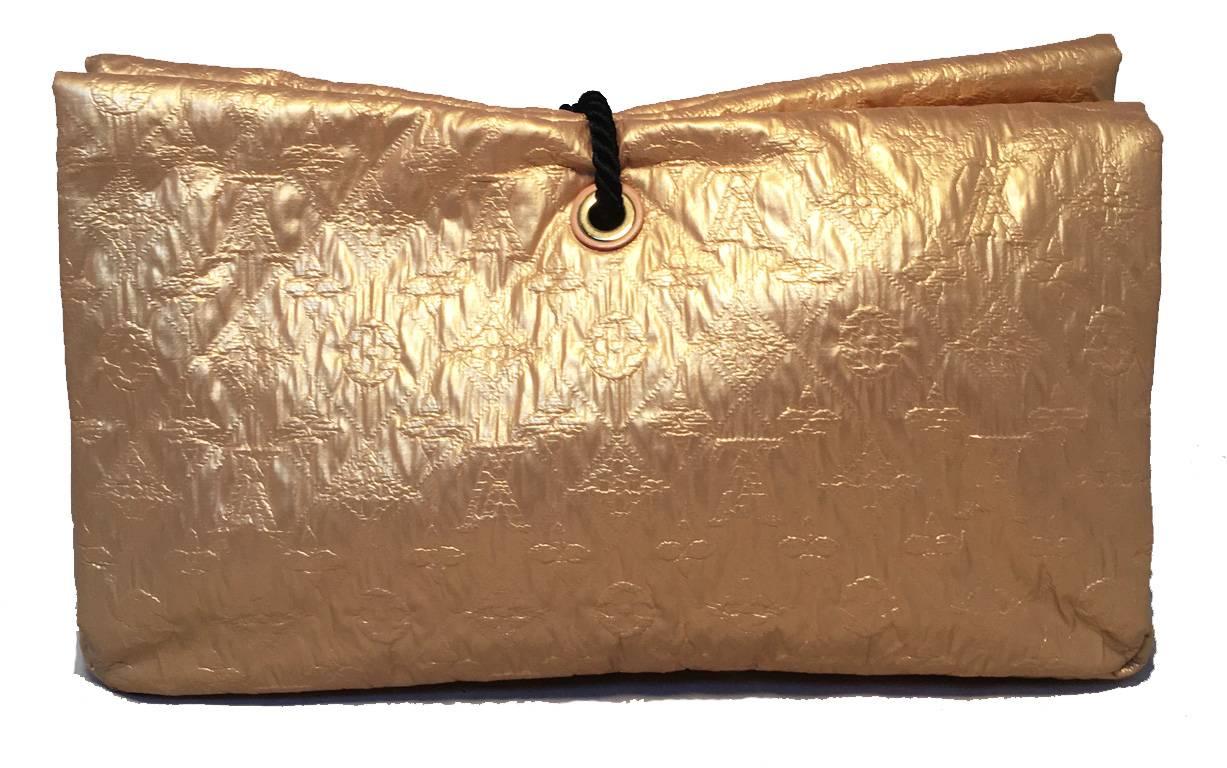 Limited Edition Louis Vuitton African Queen Masai GM Limelight Clutch in good condition. Gold monogram embossed leather exterior trimmed with resin beads. Front snap flap closure opens to a dark grey canvas lined interior that holds 1 side zippered