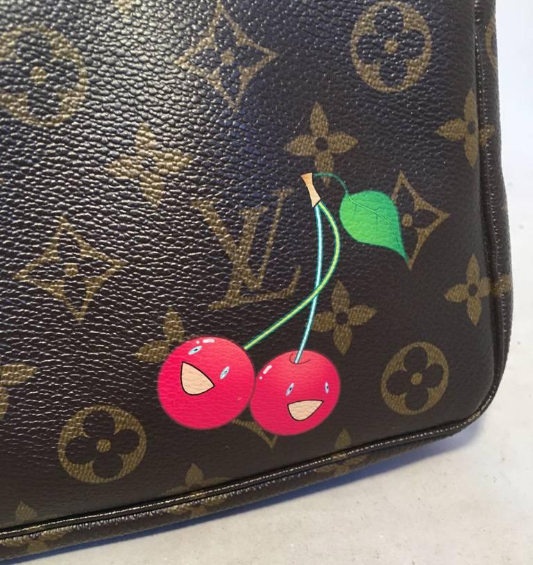 LIMITED EDITION Louis Vuitton monogram canvas Cerises pouchette with cherries in excellent condition.  Monogram canvas exterior trimmed with tan leather and gold hardware.  Two adorable painted cherries on the front exterior of this piece by famed