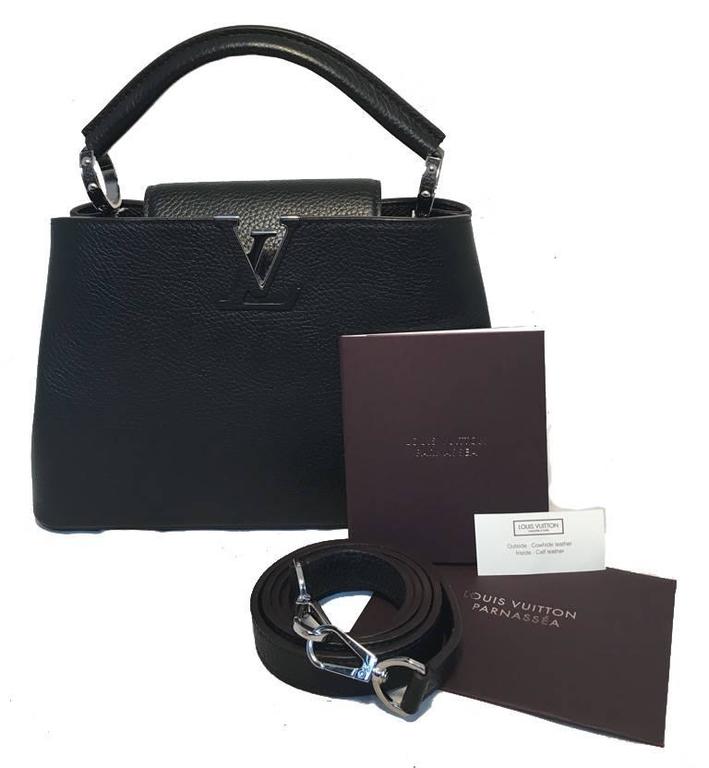 GORGEOUS Louis Vuitton Black Capucines BB Handbag in excellent condition.  Black taurillon leather trimmed with silver hardware.  Front LV logo design cut out and black leather removable shoulder strap that easily converts this piece between hand