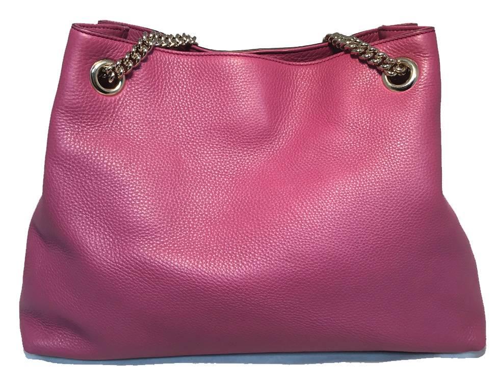 NEW WITHOUT TAGS Gucci dark pink leather shoulder bag tote in excellent like-new condition.  Dark pink mauve leather exterior trimmed with shining silver hardware, Gucci logo embroidered along front side, and a tassel detail attached to front strap.