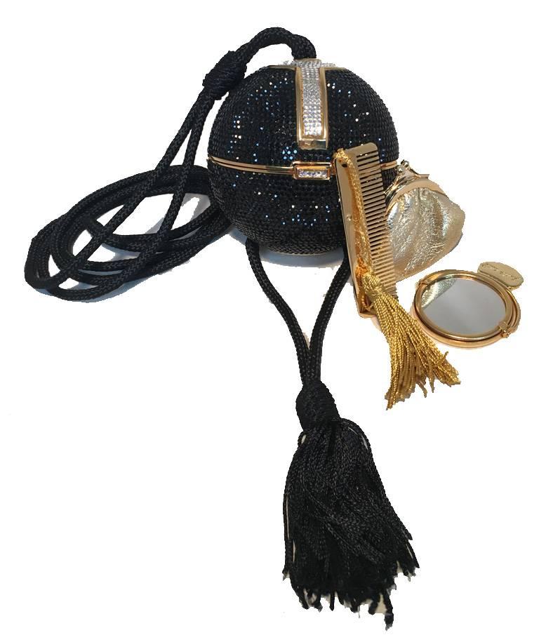 RARE Judith Leiber Black crystal sphere minaudiere shoulder bag in excellent vintage condition.  Black Swarovski crystal exterior trimmed with gold edges and clear crystals along top and side design.  Corded Silk shoulder strap with tassel detail. 