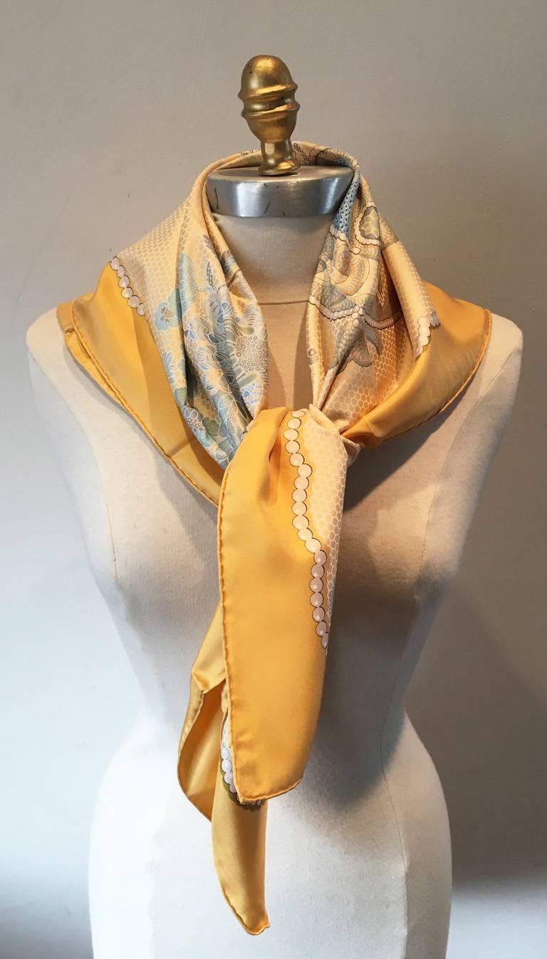 LIMITED EDITION Hermes Doigts de Fee silk scarf in excellent condition.  Original silk screen design c2000 by Caty Latham features an intricate pattern of handmade lace design and tools in greys and white over a golden yellow background.  100% silk,