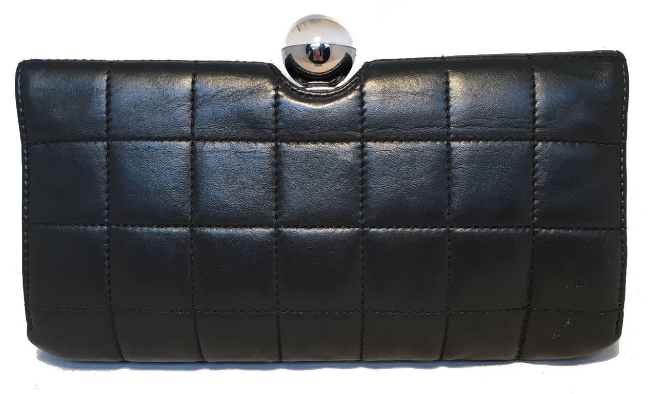 VERY RARE Chanel quilted leather crystal ball top clutch in very good condition.  Square quilted black lambskin leather exterior trimmed with silver hardware and a unique clear and silver crystal ball top detail with inlaid CC Chanel logo.  Flap