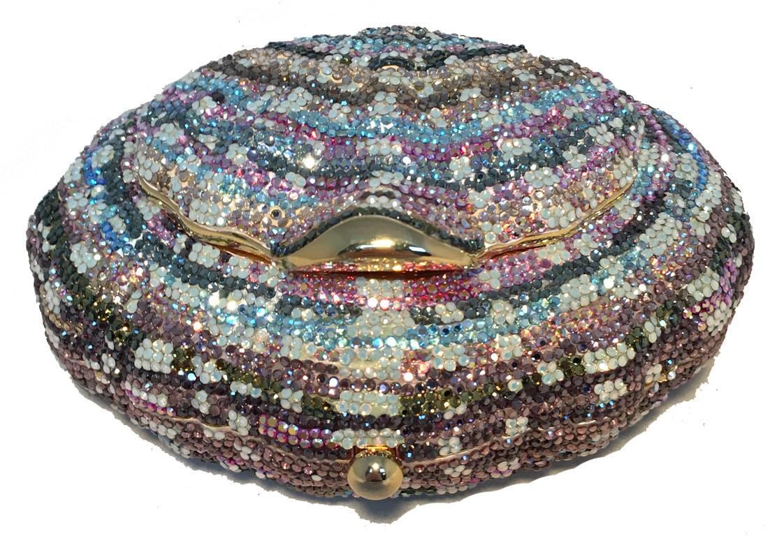 RARE Judith Leiber Swarovski Crystal shell minaudiere in excellent condition.  Multi color swarovski crystal exterior trimmed with gold hardware.  Top lifting feature opens to reveal a compact mirror.  Button closure opens to a gold leather lined