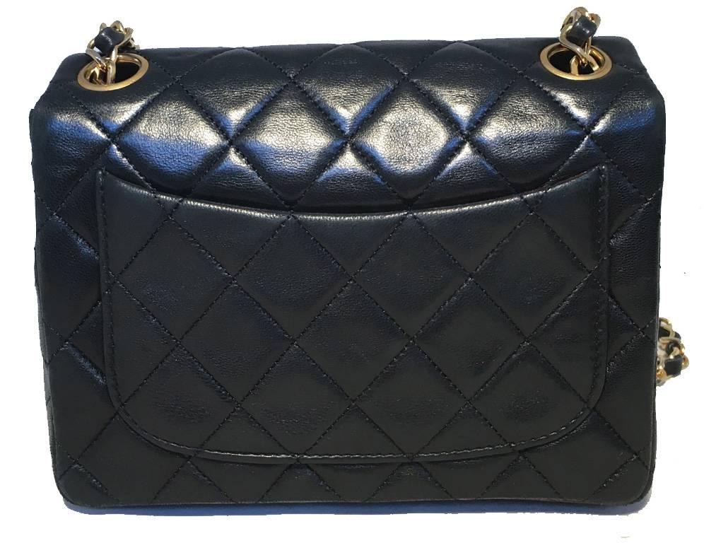 Beautiful Vintage Chanel black leather mini flap classic in excellent condition.  Black quilted lambskin leather exterior trimed with gold hardware and signature woven chain and leather shoulder strap.  Front twist CC logo closure opens to a black