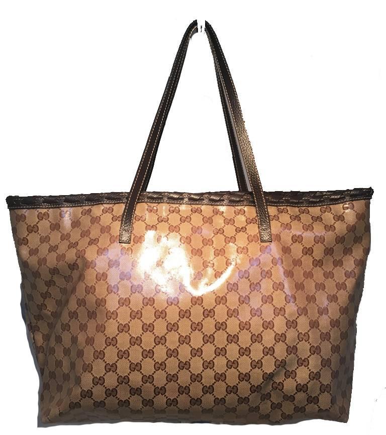 GORGEOUS Limited Edition Gucci monogram and leather tassel tote in excellent condition.  Coated monogram canvas trimmed with dark brown braided leather trim and a unique leather and bamboo tassel detail along the front side.  Brown nylon lined