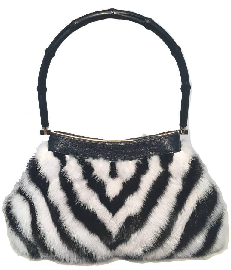 RARE Gucci black and white fur print handbag in excellent condition.  Black and white chevron zebra print mink fur exterior trimmed with a black bamboo handle and gold hardware.  Top hinged closure opens to a black woven nylon lined interior that