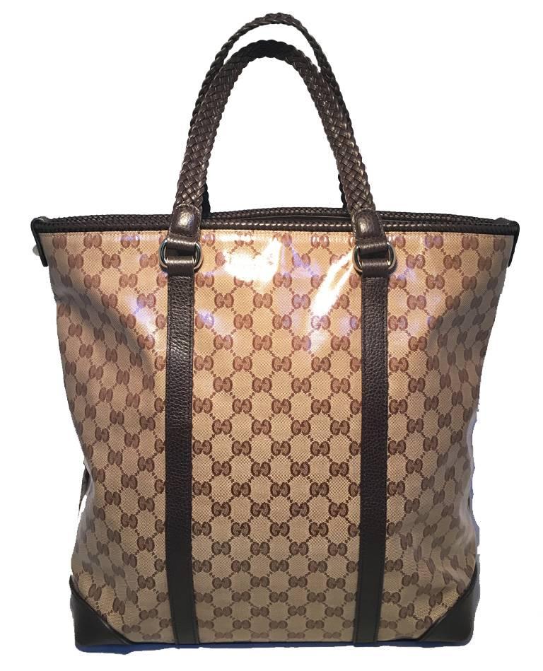 BEAUTIFUL GUCCI monogram and leather trim tote in excellent condition.  Coated monogram canvas exterior trimmed with braided brown leather and a fabulous leather tassel detail along the front side.  Top latch closure opens to a brown nylon lined
