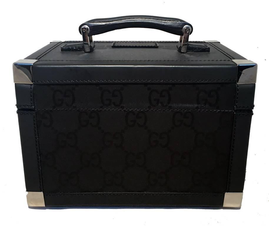 RARE GUCCI black monogram and leather train case in excellent condition.  Black monogram canvas trimmed with black leather and silver hardware.  Front latch closure opens to a black leather and vinyl lined interior with multiple elastic loops, side