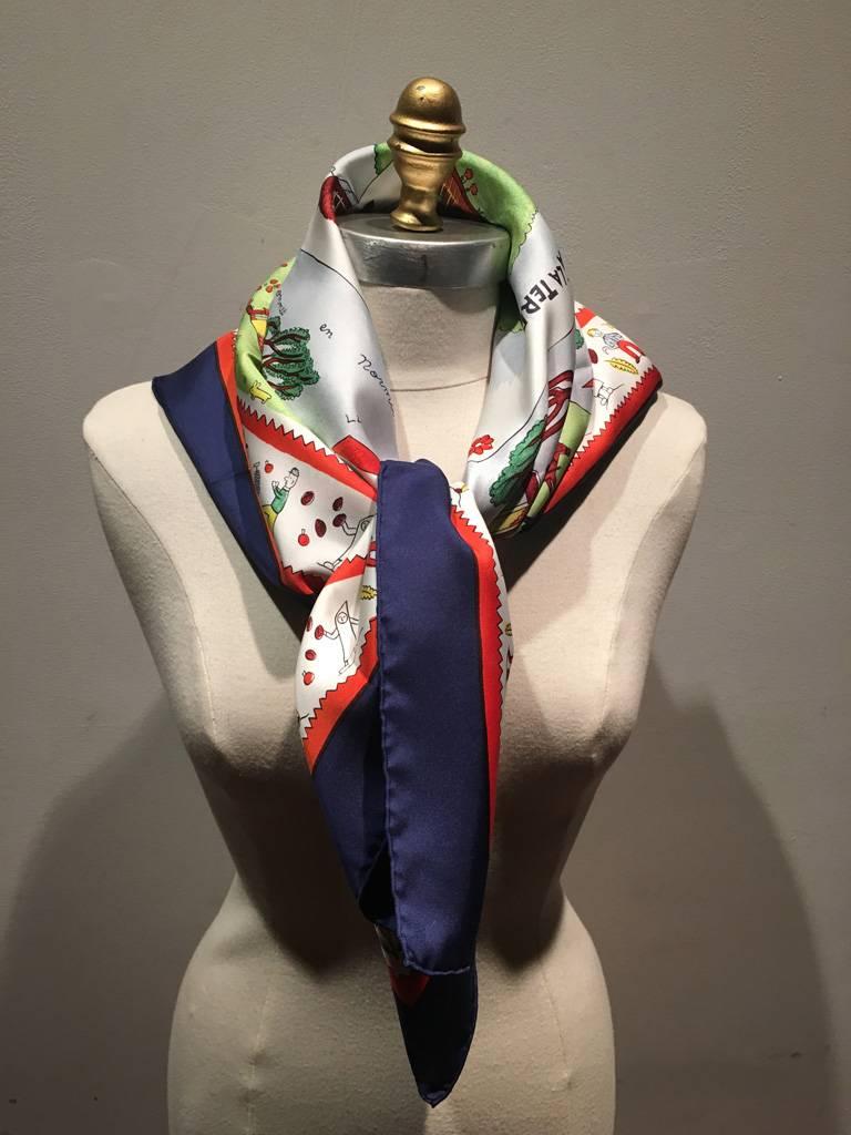 AMAZING Vintage Hermes Retour a la Terre silk scarf in excellent condition.  Original silk screen design c1940s by Oliver Dumas features a multicolor display of country side farm scenes surrounded by a navy blue and red border.  100% silk, hand