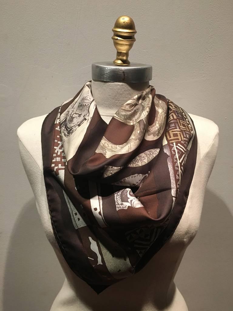 GORGEOUS HERMES Vintage Personal silk scarf in excellent condition.  Original silk screen design c1997 by Loïc Dubigeon features an array of ancient mythological statues over a brown background.  100% silk, hand rolled hem, made in France.  Signed