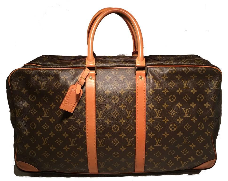 Vintage Classic Louis Vuitton Sirius suitcase in good condition.  Monogram canvas exterior trimmed with tan leather. 2 seperate storage compartments for clothes.  Overall good condition. Light scuffs on exterior leather bottom corners from use. One