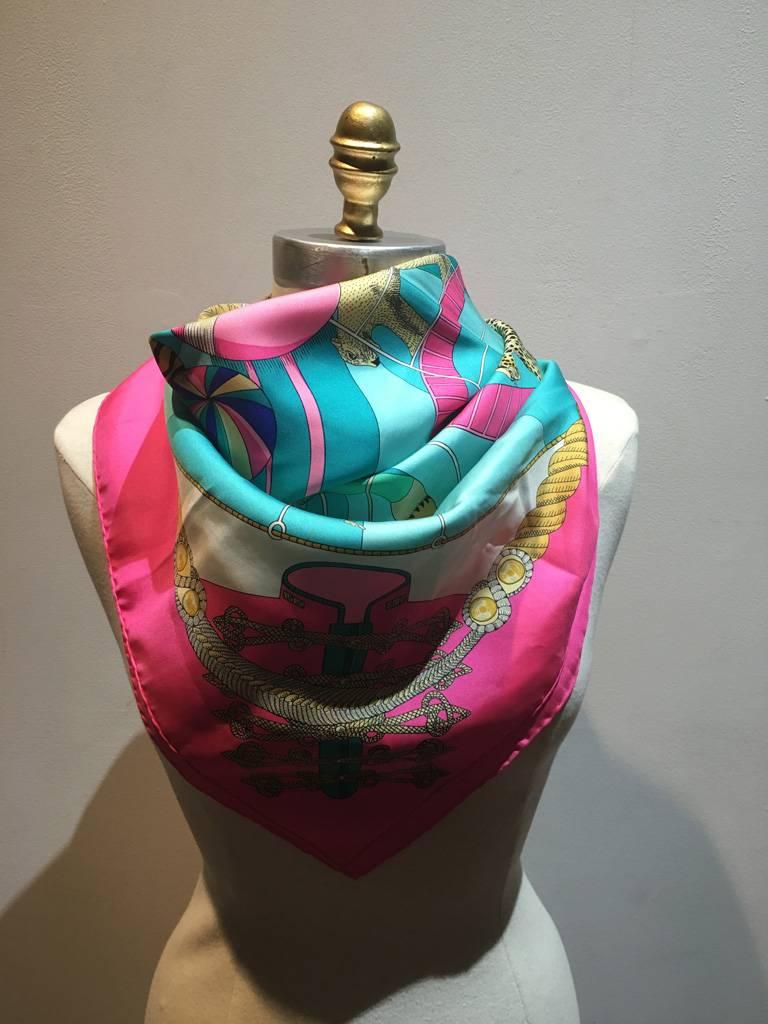 BEAUTIFUL Vintage Hermes Circus scarf in excellent condition.  Original silk screen design c1983 by Annie Faivre features a colorful depiction of a circus scene over a turquoise and white background surrounded by a bright pink border.  100% silk,